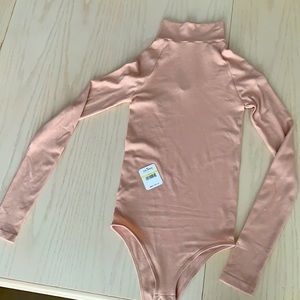 Free People Blush color bodysuit never been worn high-neck with keyhole on back.